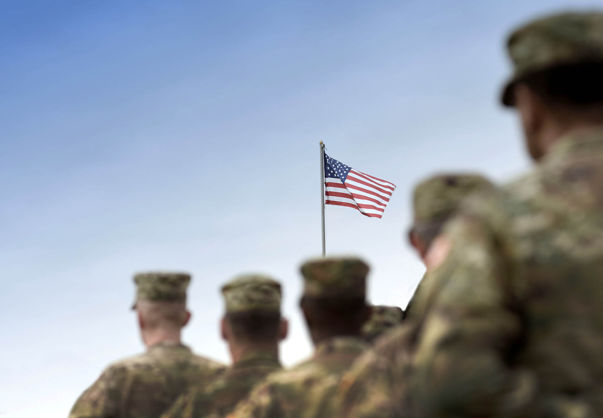 Marines standing in front of a US Flag