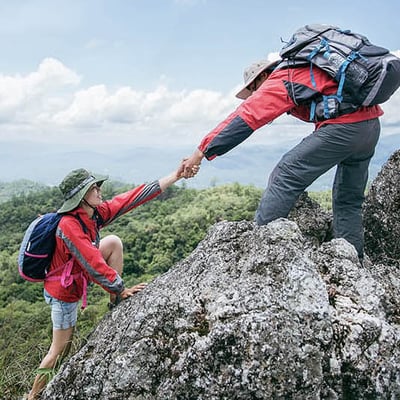 Mountain Climbers helping each other