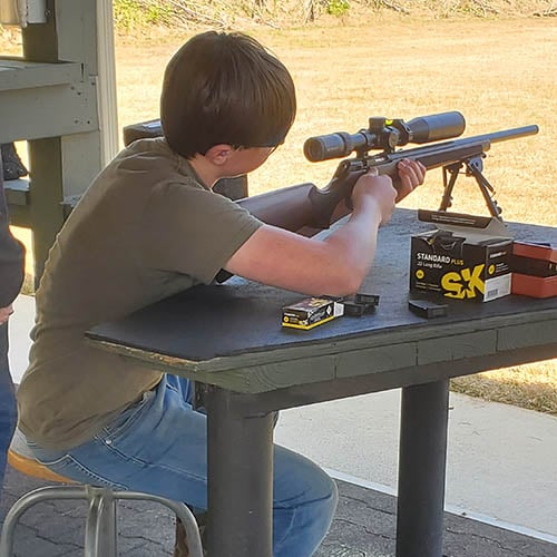 A teen athlete in a shooting competition